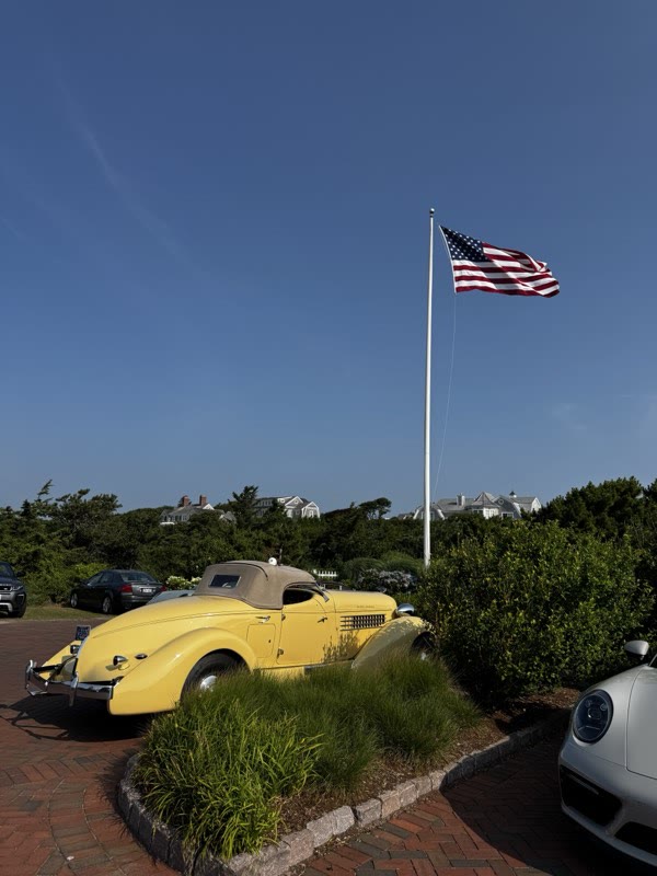 Classic cars gathered along the brick walk